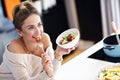 Beautiful Smiling Woman Eating Fresh Organic Vegetarian Salad In Modern Kitchen Royalty Free Stock Photo