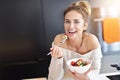 Beautiful Smiling Woman Eating Fresh Organic Vegetarian Salad In Modern Kitchen