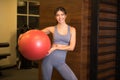 Beautiful smiling woman with exercise ball after a workout in the gym. Royalty Free Stock Photo