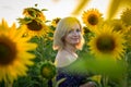 Beautiful smiling woman in the field with sunflowers Royalty Free Stock Photo