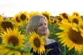 Beautiful smiling woman in the field with sunflowers Royalty Free Stock Photo