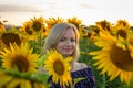 Beautiful smiling woman in the field with sunflowers Royalty Free Stock Photo