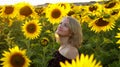 Beautiful smiling woman in the field with sunflowers Royalty Free Stock Photo