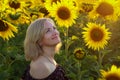 Beautiful smiling woman in the field with sunflowers Royalty Free Stock Photo