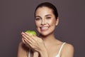 Beautiful smiling woman with green apple on brown background Royalty Free Stock Photo