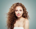 Beautiful smiling woman with healthy curly hair on gray background. Redhead girl Royalty Free Stock Photo