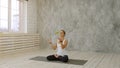 Beautiful smiling woman holding green apple sitting on exercise mat Royalty Free Stock Photo