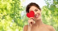 Beautiful smiling woman holding red heart Royalty Free Stock Photo