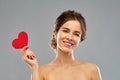 Beautiful smiling woman holding red heart Royalty Free Stock Photo