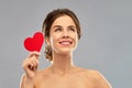 Beautiful smiling woman holding red heart Royalty Free Stock Photo