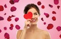 Beautiful smiling woman holding red heart Royalty Free Stock Photo