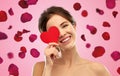 Beautiful smiling woman holding red heart Royalty Free Stock Photo