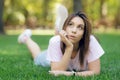 Beautiful smiling woman lying on a grass outdoor Royalty Free Stock Photo