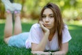 Beautiful smiling woman lying on a grass outdoor