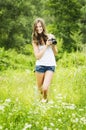 Beautiful smiling woman is professional photographer with DSLR camera and taking pictures outdoors in summer nature Royalty Free Stock Photo