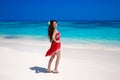 Beautiful smiling woman in red dress enjoying on exotic sea, tropical beach. summer outdoor portrait. Attractive girl model. Welln Royalty Free Stock Photo