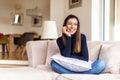 Beautiful smiling woman relaxing on the couch at home Royalty Free Stock Photo