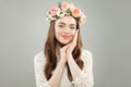 Beautiful smiling woman relaxing. Pretty model face with clear skin, long curly hairstyle and flowers. Royalty Free Stock Photo