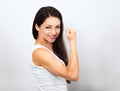 Beautiful smiling woman showing her strong biceps on the arm on blue background. Love yourself body Royalty Free Stock Photo