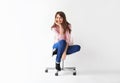 Beautiful smiling woman sitting on chair with copy space Royalty Free Stock Photo