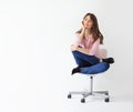 Beautiful smiling woman sitting on chair with copy space Royalty Free Stock Photo