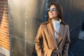 Beautiful smiling woman in s.tylish coat and sunglasses outdoors