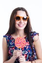 Beautiful smiling woman in summer dress with lollipop in sunglasses isolated on white Royalty Free Stock Photo