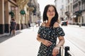 Beautiful smiling woman walking on crowded city street from work Royalty Free Stock Photo