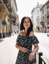 Beautiful smiling woman walking on crowded city street from work. Royalty Free Stock Photo