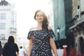 Beautiful smiling woman walking on crowded city street from work. Royalty Free Stock Photo