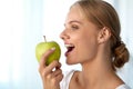 Beautiful Smiling Woman With White Teeth Eating Green Apple Royalty Free Stock Photo