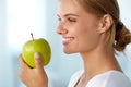 Beautiful Smiling Woman With White Teeth Eating Green Apple Royalty Free Stock Photo