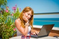 Beautiful smiling woman working on laptop. Royalty Free Stock Photo