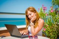 Beautiful smiling woman working on laptop.