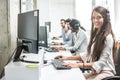 Beautiful smiling woman costumer support worker with headset using computer in call center Royalty Free Stock Photo