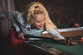 Beautiful smiling women playing billiards at a bar