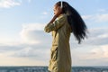 Beautiful smiling young black african american woman with long hair listening to music. Blurred cityscape on background Royalty Free Stock Photo