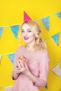 Beautiful smiling young blonde woman with a cake. Celebration and party. Royalty Free Stock Photo