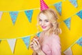 Beautiful smiling young blonde woman with a cake. Celebration and party. Royalty Free Stock Photo