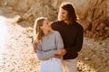 Beautiful young couple hugging while walking together at sunny beach Royalty Free Stock Photo