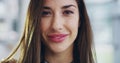 Beautiful, smiling and young female face feeling confident and charming. Portrait of a laughing woman head with a pretty Royalty Free Stock Photo