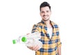 Beautiful and smiling young man offering cold water for hydration Royalty Free Stock Photo