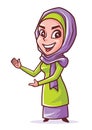 Beautiful smiling young muslim woman with hijab presenting and pointing somethin