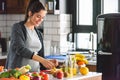 Pregnant woman preparing healthy food with lots of fruit and vegetables at home Royalty Free Stock Photo