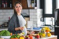 Pregnant woman preparing healthy food with lots of fruit and vegetables at home Royalty Free Stock Photo