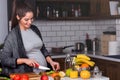 Young pregnant woman preparing healthy food with fruit and vegetables Royalty Free Stock Photo
