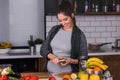 Young pregnant woman preparing healthy food with fruit and vegetables Royalty Free Stock Photo