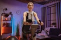 Beautiful smiling young woman doing cardio on stationary bike. Royalty Free Stock Photo