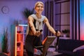 Beautiful smiling young woman doing cardio on stationary bike. Royalty Free Stock Photo