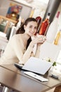 Beautiful smiling young woman drinking a cup of coffee at the cafe coffee bar, ice cream shop and pastry shop. Student girl with Royalty Free Stock Photo